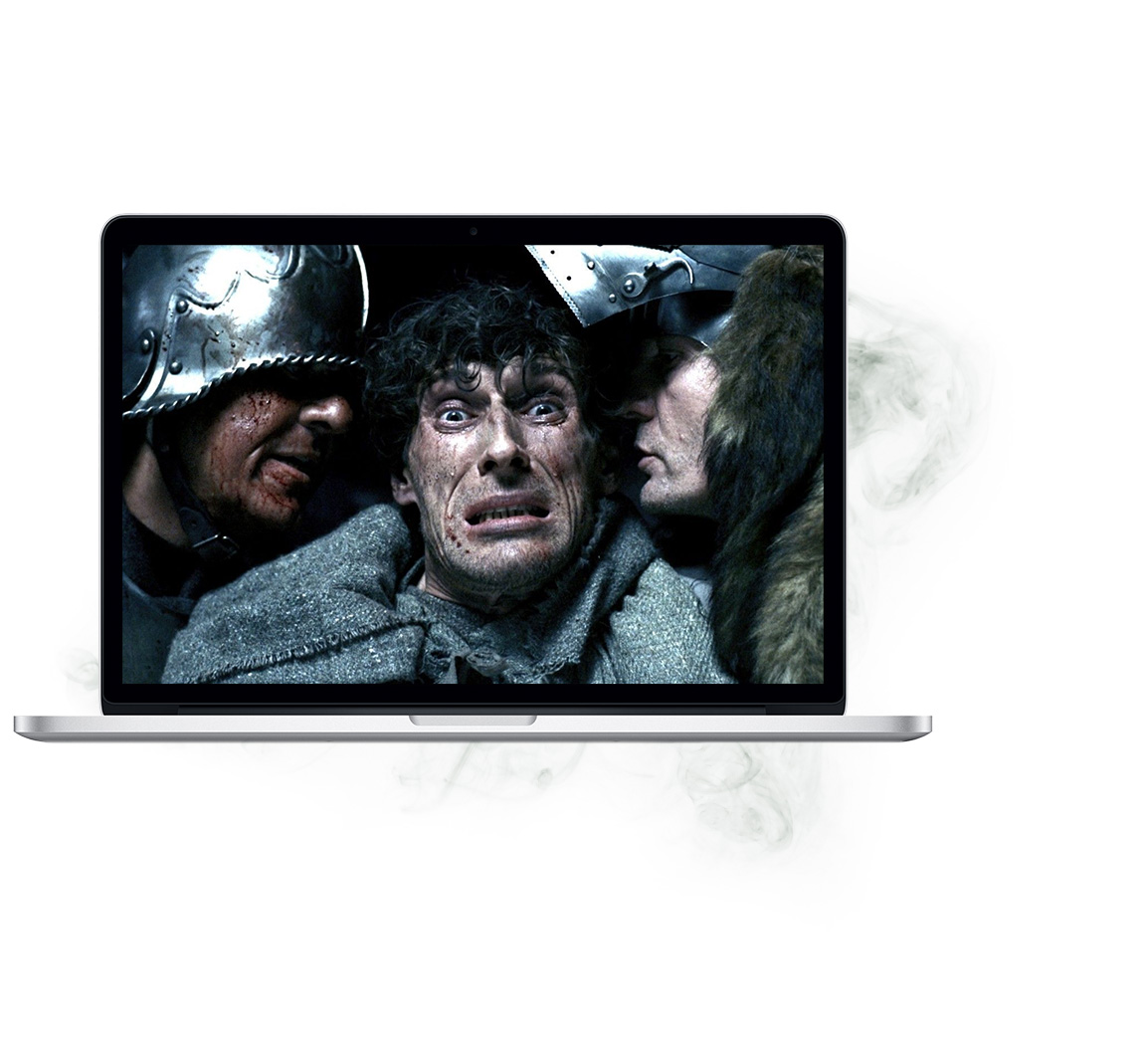 macbook with a paused night watch film